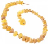 Stone beads made of light polished amber through a knot (medicinal)