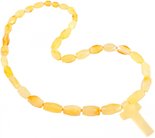 Beads made of light multifaceted amber stones with a cross