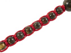Amulet beads with a red thread and greenish amber balls