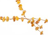 Braided beads made of polished amber stones of honey color