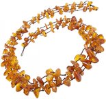 Three rows of beads made of polished amber stones