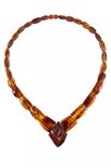 Beads made of cognac-colored amber stones (center with relief carving)