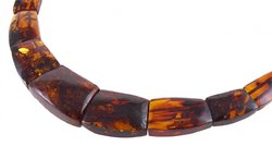 Beads made of figured amber stones of cognac color