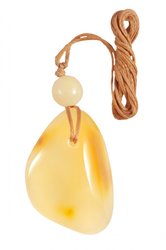 Pendant made of polished amber stone and amber ball