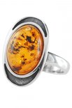 Перстень з чорненого срібла з бурштиновим кабошоном «Орлі»