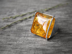 Ring with an amber stone in a silver frame “Elina”