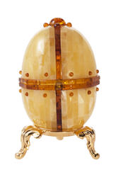 Souvenir egg made of amber plates on a stand
